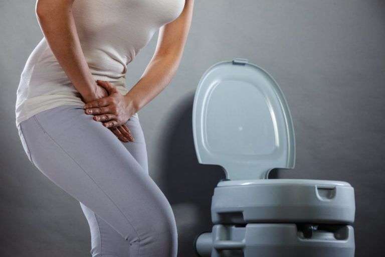 Woman suffering from Urinary Incontinence holding her ...